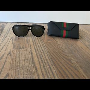 Excellent used Gucci sunglasses (unisex) black lens, with sliver trim.